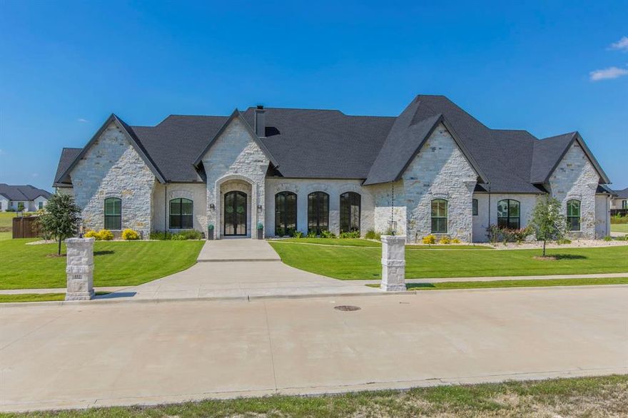 Discover this magnificent 4-bedroom, 4.5-bathroom estate nestled in The Arches of Lorena, TX. This Global Luxury property is the perfect blend of elegance, modern amenities, and timeless design. Inside, marvel at the exquisite attention to detail showcased by the beautiful hardwood flooring throughout, expansive windows that accentuate the interior with an abundance of natural light.  The heart of this home is the  Grand Living Room with hand crafted Havana Gold Chandelier with barrel ceiling, dining, and kitchen which offers plenty of room for comfortable living with family and entertaining guests. The kitchen presents top-of-the-line stainless steel appliances, Thermador refrigerator and freezer, custom cabinets, granite counter space, spacious island and a magnificent butler's pantry with quartz countertops making it a haven for culinary enthusiasts and entertainers alike. Each bedroom offers an en-suite bathroom. The primary suite is a sanctuary offering ample space and privacy, featuring a lavish en-suite bath with a freestanding tub, tile wainscoting in baths and shower, dual vanities and walk-in closet with washer and dryer. This beautiful home has a guest room or in-law suite that offers privacy, an adjacent full bathroom and kitchenette.  Additional interior features office with custom bookshelves, two laundry areas, two cozy fireplaces, dual-pane windows and automatic motorized window shutters, two tankless water heaters.  Venture outside to discover your sanctuary of relaxation, featuring an exquisite pool complete with spa and a heater system controlled by a wireless application, for year-round enjoyment. The thoughtfully designed BBQ outdoor kitchen area is perfect for dining and gatherings under the Texas stars. Additional outdoor features include an oversized 3-car garage with an electric car charger, room with a sink, and plenty room for ample parking. This Lorena home is more than just a residence; it’s a lifestyle!  Tour this home today!