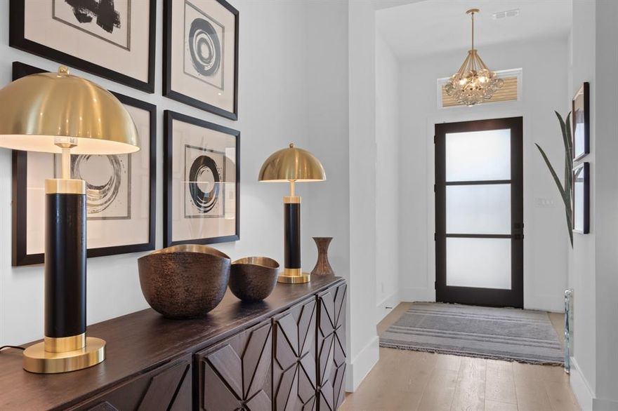Step outside and you're already there — one block from the heart of historic Downtown Roanoke, where the best restaurants, boutique shops, and community charm are yours on foot. This is downtown living with every luxury of a brand-new custom home. Completed in 2024, wide plank white oak floors and designer lighting set the tone the moment you enter. The open-concept layout flows from a beam-ceilinged dining room into a chef's kitchen built to impress — quartz countertops, high-end appliances, built-in refrigerator, oversized island, walk-in pantry, and a butler's pantry that handles everything else. The living room anchors it all with a beamed ceiling and cozy fireplace that make every evening feel like home. The primary suite is a true retreat. A custom walk-in closet, huge spa-level bath with dual rain showers, soaking tub, and floating double vanity. Upstairs, three spacious bedrooms, two full baths, and a game room offer the flexibility every household needs. Outside, a covered patio invites year-round entertaining. The garage — complete with a custom organizational system and lighted workbench — finishes the package. Thoughtfully designed, energy-efficient, and impeccably appointed. 317 Rusk is where modern living meets timeless craftsmanship in one of Roanoke's most convenient and coveted addresses.