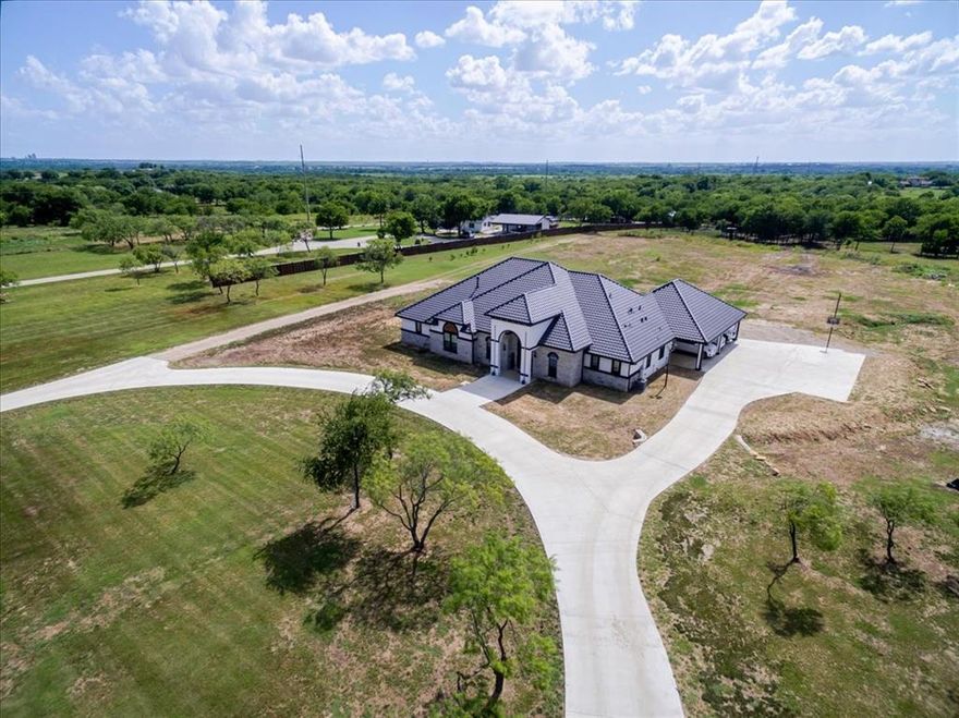 A Masterpiece of Luxury & Serenity in Sanger, Texas!
Nestled on a sprawling 9.5 wooded acres, this stunning 4,440 SF home is the perfect blend of elegance, comfort, and natural beauty. Topped with a distinctive Spanish tile roof and featuring a 4.5-car carport, this estate is a true showstopper. Enter through a custom, imported wrought iron door into a grand foyer with soaring windows and porcelain floors that flow throughout. Towering 11–13 ft doors and 70 concrete piers (18 ft deep) ensure both spaciousness and unparalleled structural integrity..
The gourmet kitchen boasts a massive granite island, 6-burner cooktop, double ovens, under-cabinet lighting, stainless appliances, and a butler’s pantry. The living room is an entertainer’s dream with a custom media wall, 98” Samsung TV, and gas fireplace.
With 6 spacious bedrooms and 5 luxury bathrooms featuring quartz counters and granite showers, privacy and comfort abound. Additional spaces include a custom office, laundry room with dual washer dryer hookups, utility sink, a gym flex room, and a game room.
Outside is where the fun begins: a 250-ft zip line, treehouse with wrap-around porch powered by generator, iron pavilion with solar lights and woodfire grill, outdoor kitchen with gas and water, and an iron swing set. The land is rich with hackberry, cedar elm, live oak, mesquite, pecan, American elm, & pine. A well and septic are in place.
Pre-wired for surround sound, alarm system, and outdoor lighting, this home is built for seamless indoor outdoor living.
This is more than a house; it's a lifestyle. Don't miss the opportunity to own this extraordinary estate in Sanger, Texas!