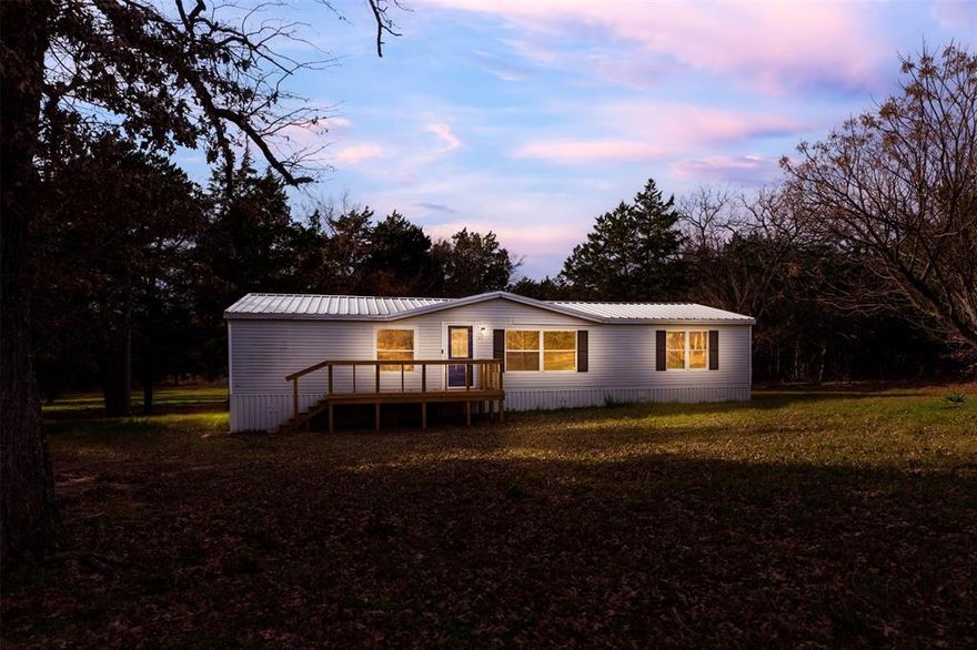 Escape the noise and embrace true country living with this NO HOA, off-grid retreat on nearly 10 acres of beautiful, wooded land! Tucked beneath towering, mature trees, this refreshed 4-bedroom, 2-bath open-concept home offers the perfect blend of comfort and freedom. Recent updates include fresh interior paint, newly painted cabinets throughout, a new water heater, and brand-new front and back porch decks—ideal for morning coffee or sunset views surrounded by nature. Unrestricted land provides endless possibilities to create your own peaceful escape, homestead, or dream retreat. Spend your days unwinding in total privacy while watching deer, foxes, owls, hawks, and an abundance of songbirds right outside your door. An assumable FHA loan adds incredible value, and the transferable home warranty offers peace of mind, covering the home, roof, septic, and appliances. This is your chance to unplug, recharge, and live the lifestyle you’ve been dreaming of!