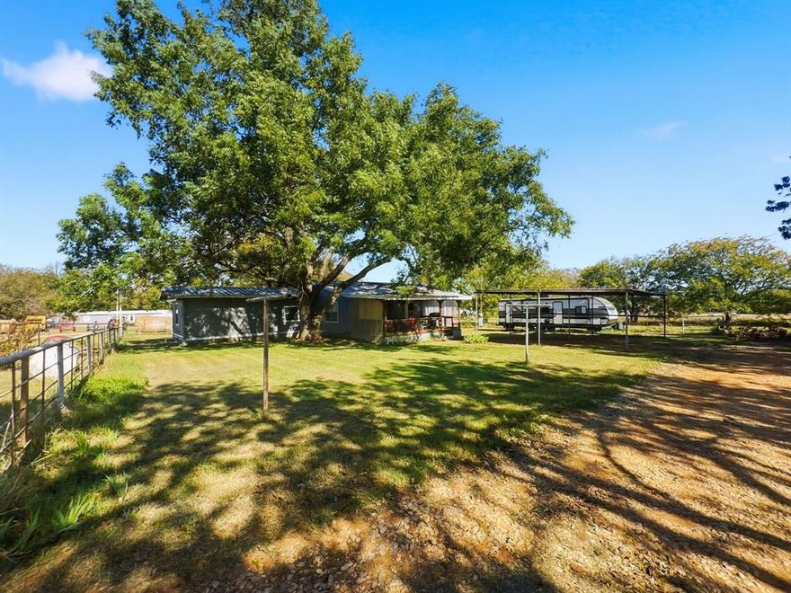 Enjoy peaceful country living on a full acre just minutes from Gainesville with this 2-bedroom, 2-bath home on FM 371. Shaded by large mature pecan trees, this property offers great outdoor space and a relaxing rural setting. The home is very livable as it sits, but could use some updates and personal touches—perfect for a handyman, investor, or anyone looking for an affordable place in the country. Inside, you’ll find a comfortable layout with a spacious living room, open kitchen with plenty of cabinet space, and two full bathrooms for convenience. Step outside to a covered porch ideal for morning coffee or evening sunsets. A 2-car carport and storage building add valuable utility and space for tools, equipment, or hobbies. Being sold as is, this property offers peace, potential, and country charm—all just a short drive from Gainesville and major highways.