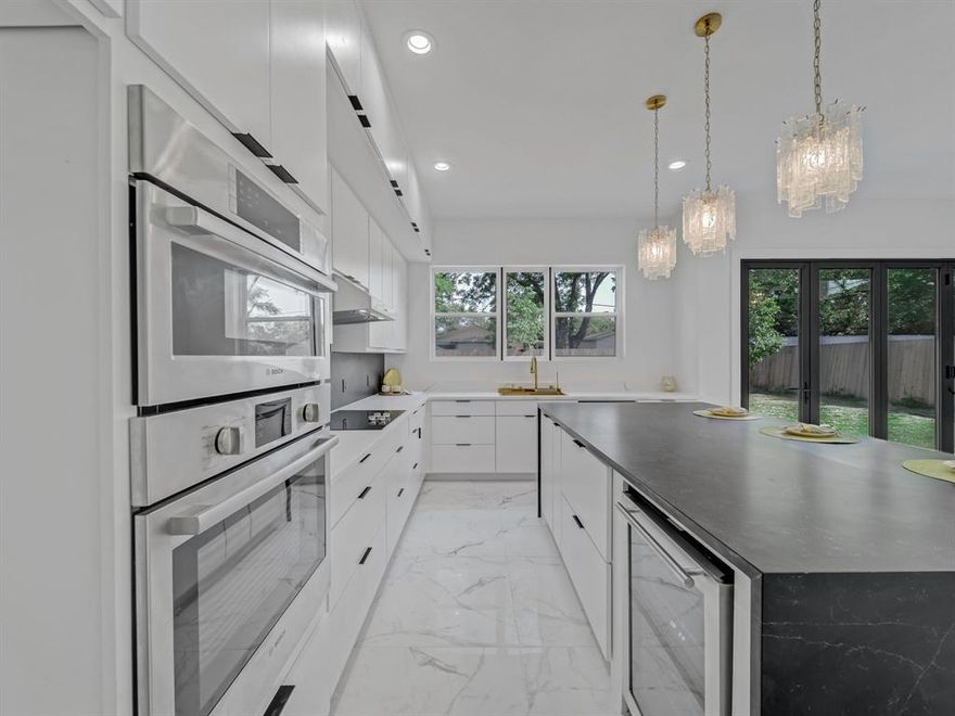 Sleek Sophistication Just Minutes from Downtown – Be the First to Live in This Modern Masterpiece. Welcome to a residence where modern luxury meets everyday functionality. This brand-new, never-lived-in home offers over 2,900 square feet of meticulously designed space, featuring 4 spacious bedrooms and 4 full bathrooms, perfect for today's flexible lifestyles, working from home, or simply indulging in comfort. From the moment you enter, you're greeted by a bold architectural statement—floating stairs, soaring ceilings, and clean lines that create a sense of openness and drama. The all-white palette is paired with striking black and gold accents, offering a timeless, high-contrast aesthetic that’s both classy and cutting-edge. The heart of the home is the stunning open-concept kitchen, designed to impress with a black quartz waterfall island, complete with an electric cooktop, vent hood, built-in wine fridge, and crisp white quartz countertops. A walk-in pantry ensures plenty of storage without sacrificing style. Entertain in style or relax in comfort in the main living area, anchored by a bold black porcelain tile fireplace—a true focal point of the home. Upstairs, retreat to a luxurious primary suite, large enough to accommodate a king-sized bed plus a lounge or office space. The spa-inspired bath features a soaking tub, glass-enclosed shower, dual sinks, and elegant fixtures. A custom walk-in closet includes a full-length mirror and smart storage solutions. Two more bedroom suites upstairs each offer ample closet space and private baths—ideal for roommates, guests, or family. A cozy loft space can serve as a second living area, reading nook, or creative workspace. On the main floor, the fourth bedroom and full bath provide ultimate flexibility—perfect for guests, an in-law suite, or a dedicated home office. Outside, enjoy an oversized backyard with endless potential.