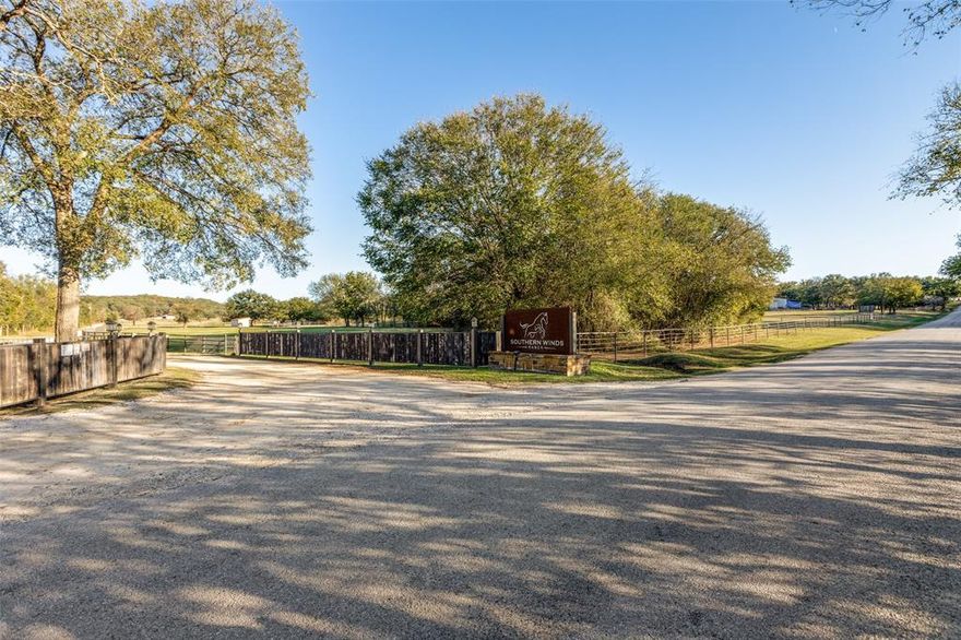 Discover Southern Winds Ranch, 81+ acres of picturesque rolling terrain, perfectly situated near Lake Ray Roberts. This ranch features a main home, guest home, and staff apartment. The horse facilities include 4 barns, totalling 47 stalls.  The two show barns total 21 stalls, and have an office, lounge, wash racks, tack rooms, fly spray system, and automatic waterers. The Mare motel has 20 stalls, stocks, and a lab. Finally, there is a 6 stall quarantine barn. Enjoy training and riding in the expansive 100' x 200' lighted indoor arena, equipped with professional Kiser footing and screens. Let your horses unwind on beautifully groomed private riding trails. 60' x 60' covered area to add an additional covered horse walker or round pen. Fenced and cross fenced with pipe and no-climb fencing offering a total of 16 paddocks. The property boasts two private stocked lakes. Relax in the stunning European-style main home, which features an inviting pool and plenty of space to unwind. Home is designed to accommodate two families with two kitchens, dinings, living and primary bedrooms. Don’t miss this opportunity to own a special piece of Texas. Additional Land Available.
