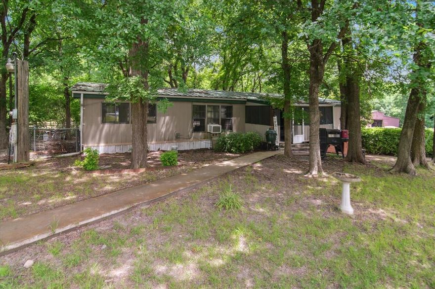 This property consists of a 3 bedroom 2 bath manufactured home and a metal building for storage or workshop or garage that is 40 x 30.  Also consists of a wood storage building and a barn with stalls.  This is a great private place to live or an outstanding investment property.  School system is outstanding.
There is no HOA but there is a road maintenance agreement that is $180 per year.