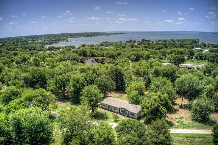 Charming and FARMHOUSE CUTIE! Doublewide on 2+ Acres in Lone Oak ISD! Tucked among hardwoods, pecan trees and orchard varieties, this beautifully set home offers peaceful country living with modern comfort. Located in a waterfront community, enjoy easy access to a private park and boat drop, perfect for lake days and weekend escapes. 
This freshly painted, Very Modern Appeal, move-in ready home features an open floor plan with 4 spacious bedrooms, brand new carpet and thoughtful detailing throughout. The gently rolling terrain adds to the natural beauty, making this the perfect place to relax, garden or entertain.