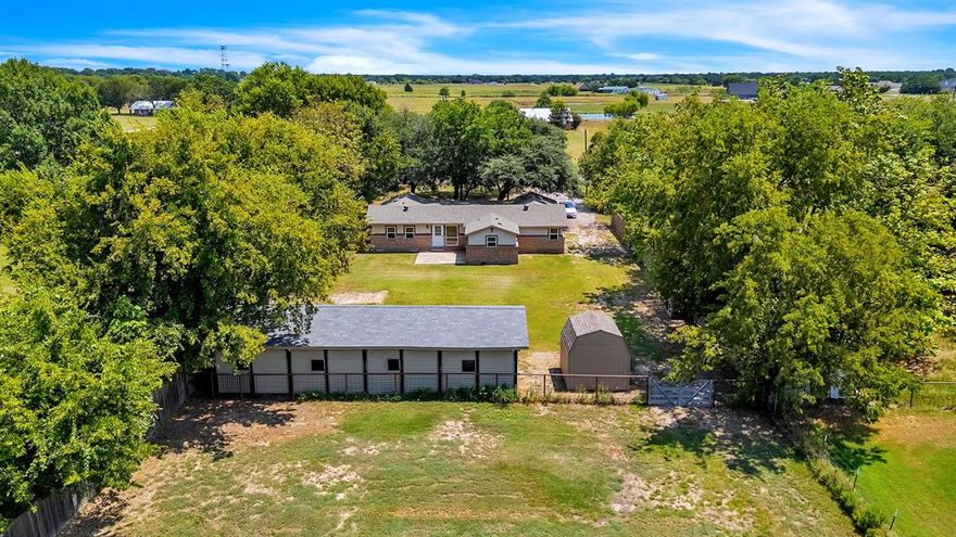 Experience the charm of country living on this beautiful tree-lined property on 1.26 acres, complete with a three horse-stall stable and a delightful chicken coop.  Perfect for the equestrian enthusiasts or anyone seeking a serene rural lifestyle, this home blends rustic appeal with modern upgrades.  Inside, you'll find granite countertops, new carpet, and all-new windows, with a roof replaced in 2023 for peace of mind.  Designed for entertaining, the spacious layout features three inviting living areas-ideal for hosting large gatherings with family and friends.  Whether you're enjoying the wide-open outdoor spaces or the comfort of upgraded interiors, this property offers the perfect blend of function, beauty, and tranquility.  Property qualifies for USDA loan.