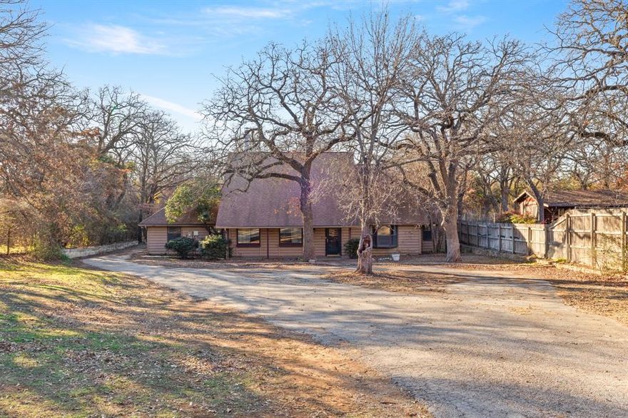 **Offer Deadline: Monday, 1-22-24 at 6pm**  Rare find in Grapevine! Minutes from Grapevine Lake, this log cabin-style home sits on a large secluded lot with abundant trees. Enjoy a peaceful environment on a dead-end road without sacrificing city conveniences. Follow the circular driveway to the home with rustic charm inside—double-sided fireplace, chef's dream kitchen, and a spa-like primary bathroom with jetted soaking tub and sauna. 4th bedroom downstairs is currently being used as a study. Upstairs floorplan is perfect for sharing with living room between bdrms. The covered back porch spans the length of the home, complemented by an open patio with a stone fireplace. Ample parking with a long driveway, 3-car tandem garage, and carport. Convenient to DFW Airport and major highways for an easy commute. Bring your imagination & make this dream home! Being sold AS-IS.