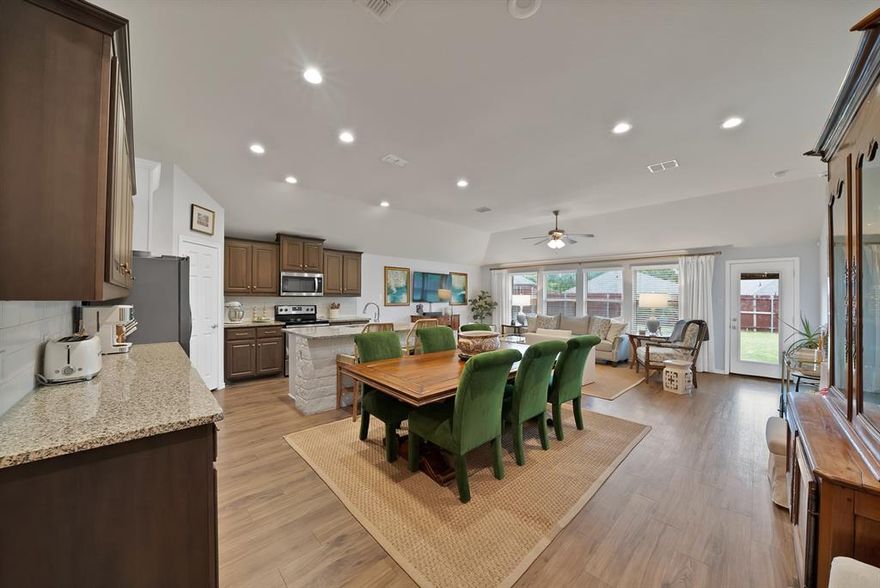 Well-maintained 4-bedroom, 2-bath home with an open layout and great natural light. The kitchen opens to the living and dining areas and features granite countertops, a large island, ample cabinet space, a built-in wine rack, and space for a coffee bar. Private owner’s suite off the living room with dual sinks, separate shower, and a walk-in closet. Durable LVP flooring in the main areas and an oversized utility room. Good-sized backyard with plenty of space to enjoy.