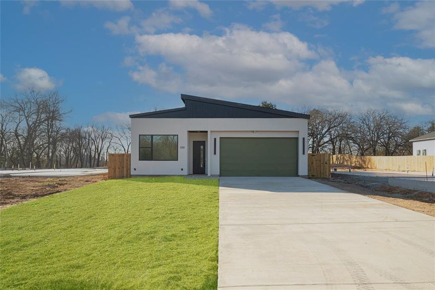 Stunning New Modern Build Backing to the Trinity River Experience contemporary living at its finest in this brand-new 3-bedroom, 2.5-bath home nestled on a spacious 0.325-acre lot in Dallas. This 2025 modern masterpiece offers 1,888 sq. ft. of beautifully designed living space with clean architectural lines and high-end finishes throughout. The open-concept layout welcomes you with soaring ceilings, luxury vinyl plank flooring, and a light-filled living room featuring a sleek electric fireplace as its focal point. The chef’s kitchen is a showstopper with a large island, built-in cabinetry, an eat-in dining area, and premium stainless steel appliances. The primary suite offers a serene retreat with an accent wall, custom closet system and a spa-inspired ensuite showcasing dual vanities and a massive walk-in shower with body sprays. Step outside to the covered back patio and take in peaceful views of mature trees and the Trinity River backdrop — the perfect setting for outdoor relaxation or entertaining. Additional highlights include a two-car garage, energy-efficient systems, and a spacious fenced backyard. Located just minutes from downtown Dallas, this home blends urban convenience with natural tranquility — a rare opportunity to enjoy modern design and riverfront living in one incredible package. New construction complete. Schedule a showing today!