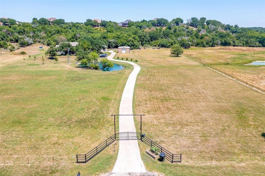 Welcome to an exquisite sanctuary nestled in the heart of Aledo! This modern +-3,904 square foot residence boasts a perfect blend of elegance and comfort, spread across +-10 lush acres. Four spacious bedrooms and three luxurious bathrooms, designed to cater to your every need. Upon entering, you're greeted by expansive living spaces adorned with contemporary finishes that seamlessly blend with the serene natural surroundings. The gourmet kitchen, equipped with top-of-the-line appliances and sleek countertops, is a chef's dream come true. Oversized master suite with en-suite bath and walk-in closet. Step outside to discover your personal oasis: a shimmering pool invites you to unwind, while two tranquil ponds provide a picturesque backdrop for outdoor gatherings and moments of reflection. The sprawling grounds offer endless possibilities for recreation and relaxation. A +- 1200 square foot shop offers space for livestock, storage, or equipment. Experience the epitome of modern living in a setting that offers privacy and peace. This is more than a home; it's a lifestyle.