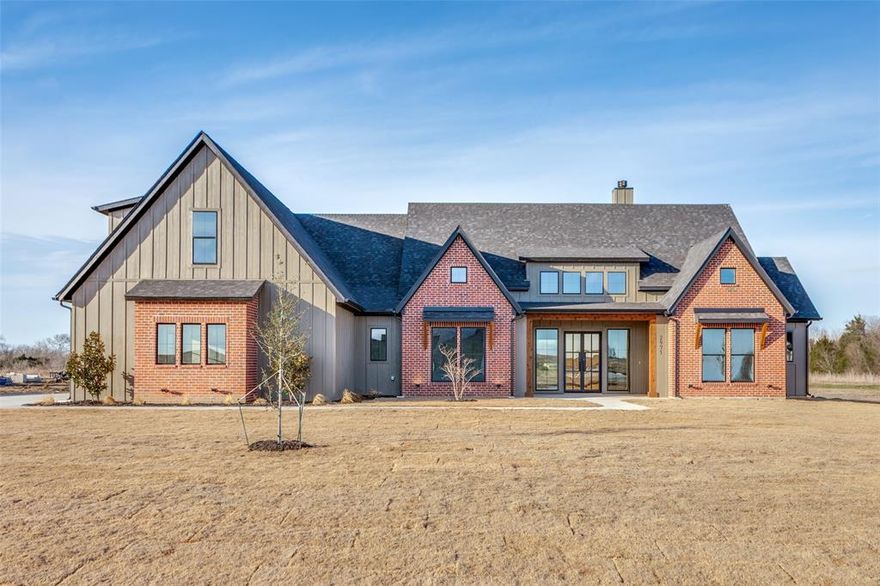 Start the new year in a beautifully crafted home by Zellea Homes, located in Carrera Ranch and just minutes from shopping and dining. This 3,242 sq ft residence sits on a spacious 1.3-acre lot and showcases the quality, craftsmanship, and upgraded finishes expected of a true custom build. High ceilings, abundant natural light, and a thoughtfully designed layout create a warm and inviting atmosphere from the moment you enter. The open-concept living areas flow seamlessly into a well-appointed kitchen featuring custom cabinetry, quartz countertops, and a large island that serves as the heart of the home—perfect for everyday living and entertaining. The living room is anchored by a wood-burning fireplace, adding warmth and character while creating a cozy focal point. Natural wood accents throughout the home enhance the timeless appeal rarely found in standard construction. An expansive outdoor patio provides an exceptional extension of the living space, ideal for hosting gatherings or enjoying quiet evenings while taking advantage of the privacy and flexibility of the 1.3-acre setting. Upstairs, a bonus room with a private bathroom and closet offers a versatile space that can easily function as a media room, home office, game room, or guest retreat. Built with attention to detail throughout, this home delivers the space, style, and finishes of a true custom residence.