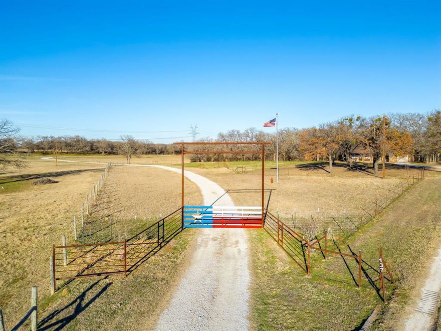 Boyd Pasture Ranch offers approximately 39 acres of productive North Texas land with a home, barn, and pasture located just outside Boyd.
This well-rounded property combines a comfortable country home, productive pasture, and functional agricultural improvements, offering excellent potential for livestock, horses, or rural living within convenient distance of the Fort Worth area.
The ranch features gently rolling pastureland with approximately 8 acres of coastal Bermuda grass, typically producing multiple cuttings per year. The remaining acreage provides open grazing with scattered trees and a wet-weather creek that winds through the property. A small pond near the front of the ranch holds water year-round and provides an additional water source for livestock and wildlife while adding to the natural setting of the property. Deer and turkey are commonly seen on the property.
Improvements include a four-bedroom, two-bathroom home offering approximately 2,400 square feet of living space and approximately 2,800 square feet under roof including porches and garage. The home was originally constructed as a barndominium in 2000 and later expanded and updated in 2014 into a more conventional residence. Interior and outdoor fireplaces provide comfortable gathering spaces for family and guests.
Additional improvements include an approximately 60-foot by 60-foot barn constructed in 2005–2006 featuring a roll-up door, fenced turnout, and multiple stalls including two smaller stalls and a larger stall beneath the barn wing. The barn includes water service.
The ranch is currently cross-fenced and supports cattle while maintaining an agricultural tax exemption. The property could easily transition to a horse property or other agricultural use. A designated gun range area has also been established for recreational shooting.
Utilities include Wise Electric Cooperative service, a water well, septic system, and a 500-gallon propane tank servicing the oven, stove, and fireplace.