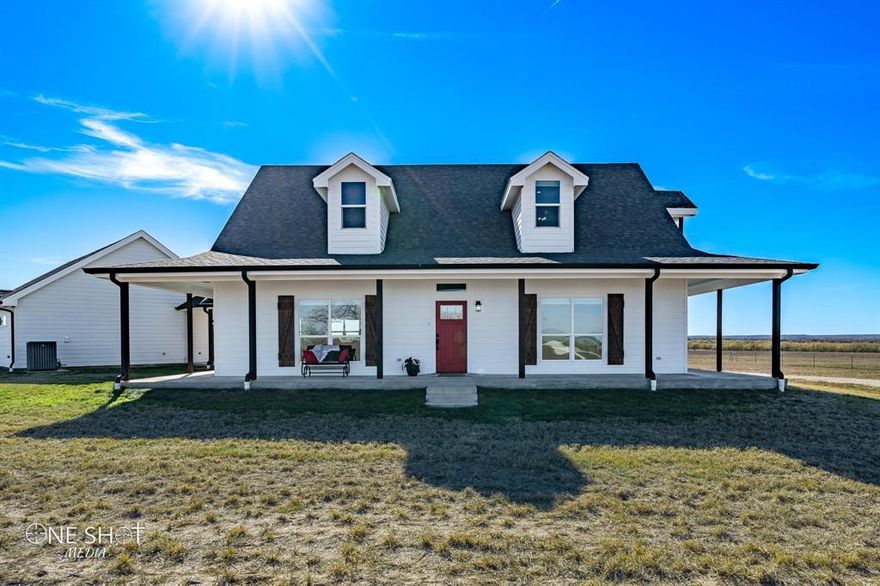 Country living awaits in captivating custom home in Clyde, easy commute to Abilene. Outside city limits, move-in ready! Beautiful & inviting foam insulated farmhouse w-abundant storage, wraparound porches & stunning views in Eula ISD, easy access to Hwy 36 & 120. Oversized 4-car garage + workbench & stair entry to attic. Well lit, ceramic tile, gas fireplace, zoned HVAC w-smart thermostats, tankless water heater, multi-zoned home entertainment system. High speed internet! Dream kitchen w-walk-in pantry, custom cabinets, quartz countertops, large island w-seating, upgraded black stainless GE appliances, 6 burner gas stove, double oven, farmhouse sink, pass thru to outdoor bar. Retreat to primary bedroom w-luxurious private ensuite to relax in Kohler massage air tub-walk-in shower, reading in the nook, or step out on the balcony to enjoy the sunset with a drink from the in-room bar. Plenty of space to park toys, have animals, or simply take in the wildlife & beauty of the Big Country!