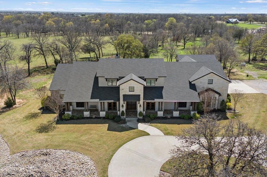 Experience the perfect blend of luxury, privacy, and ranch living on this breathtaking 68.88-acre estate in the heart of North Texas Horse Country. Naturally protected by scenic Pecan Creek, the property features rolling pastures, mature trees, and wide-open Texas skies—creating a peaceful retreat that feels worlds away while remaining just minutes from the North Dallas Tollway.

At the heart of the property sits an impressive custom-built ranch-style home offering over 5,000 square feet of thoughtfully designed living space. With 4 spacious bedrooms and 5 baths, the home showcases exceptional craftsmanship and an open-concept layout ideal for everyday living and entertaining.

The gourmet kitchen, complete with premium appliances and generous workspace, flows seamlessly into the expansive living area anchored by a dramatic floor-to-ceiling stone fireplace. A wall of windows fills the space with natural light while framing breathtaking views of the pastures.
Designed for outdoor enjoyment, the breakfast room and main living areas open to a covered patio with a fully equipped outdoor kitchen and grill and a relaxing fire pit area—perfect for gatherings or quiet evenings under the Texas sky.
The ranch also offers functional amenities, including a cattle barn and ranch manager’s quarters, ideal for equestrian pursuits, livestock, or a fully operational ranch.
Whether you seek a luxury country estate, equestrian property, or a legacy ranch, this property offers the rare combination of privacy, comfort, and accessibility in one of North Texas’ most sought-after rural communities. Buyer and Buyers agent should independently verify the information provided.  This ensures accuracy and reliability in all transactions.