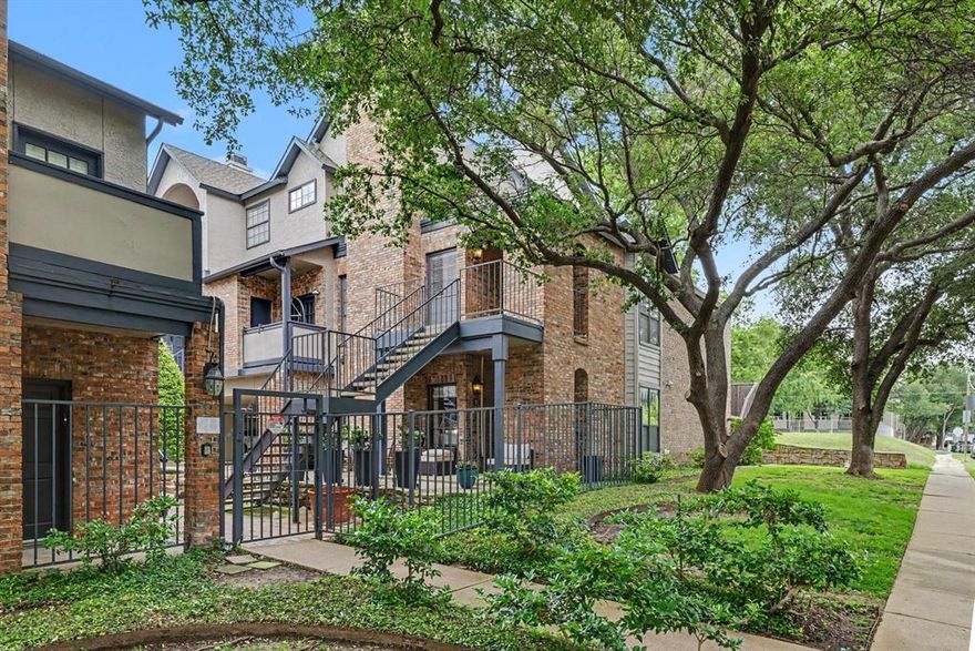 Experience top-tier city living in this rare top-floor Uptown condo. Nestled in a secure gated community, this two-bedroom, two-bathroom corner unit offers ultimate privacy with neighbors on just one side. The corner location also floods the home with beautiful natural light. You will enjoy two covered parking spaces and an amazing location near the Katy Trail, Cole Park, West Village.

The bright, open layout is ideal for entertaining guests. Cook with ease in a kitchen packed with lots of cabinet space, granite countertops, and a breakfast bar. The home also features a spacious living area with a cozy fireplace, rich wood flooring, and a separate dining area.