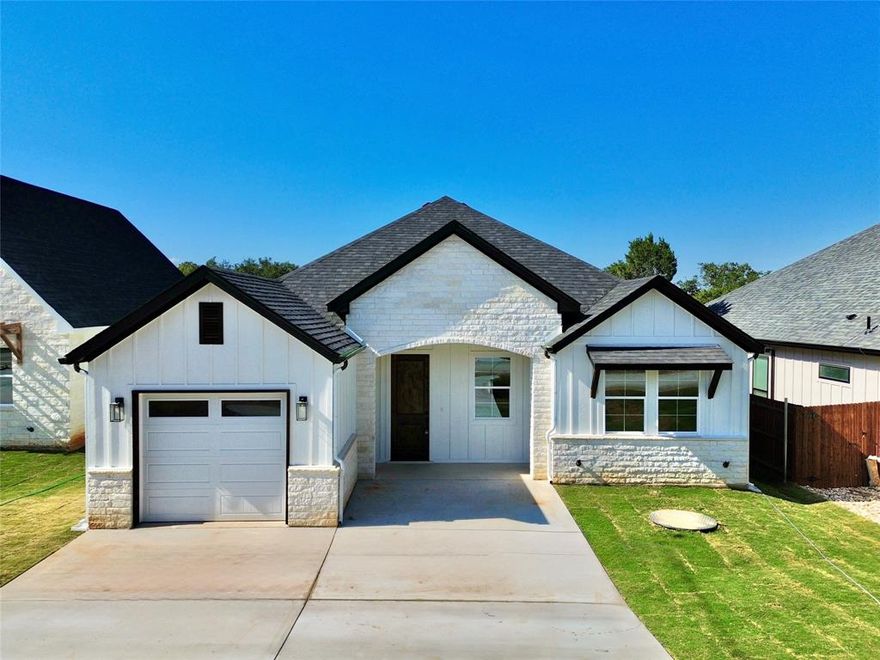 Discover unparalleled elegance and craftsmanship in this breathtaking modern farmhouse, masterfully built by renowned Carrera Homes. Nestled in a vibrant, family-friendly community with direct access to Lake Granbury, this stunning home blends timeless sophistication with modern functionality, offering the perfect backdrop for your dream lifestyle.

From the moment you arrive, the home’s striking white stone exterior and grand stone archway at the entrance captivate the senses, exuding curb appeal and architectural charm. Step through the front door into a bright and airy open floor plan, thoughtfully designed to create seamless flow for both everyday living and grand entertaining. The heart of the home is the gourmet kitchen, featuring exquisite custom cabinetry and a large, strategically placed window that floods the space with natural light, creating a warm and inviting atmosphere. Whether you’re preparing a family meal or hosting a gathering, this kitchen is as functional as it is beautiful.

The spacious master suite is a true retreat, boasting an expansive bathroom with luxurious finishes and an oversized closet that provides ample storage. Throughout the home, thoughtful details like spray foam insulation ensure energy efficiency and comfort year-round, while the extended driveway offers generous parking for guests. The full-size laundry room, adorned with stylish decorative tile, elevates daily chores into a delightful experience, combining practicality with aesthetic appeal.

Beyond the home’s impeccable design, the community amenities elevate this property to a lifestyle destination. The community fishing pond offers a tranquil spot for casting a line, while the playground, community pools, and basketball court provide endless opportunities for recreation, fitness, and family fun. 

This Carrera Homes masterpiece is more than just a house—it’s a lifestyle. Schedule your private tour today!