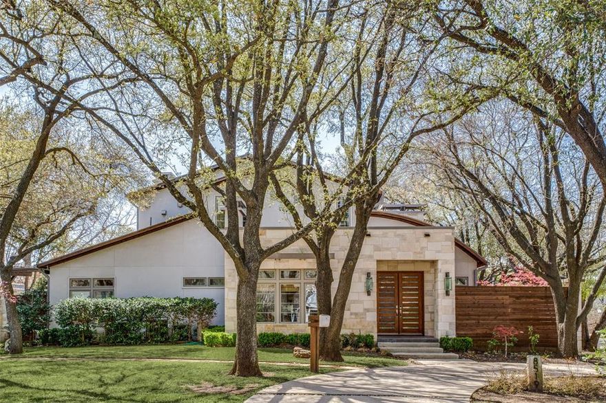 Stunning transitional home in the heart of Bluffview, on large corner lot. Gorgeous hardwoods, large windows & sleek architecture greet you as you enter.An entertainer's dream, this home has an open floor plan with a large formal living with a dual sided fire place and wet bar. Gourmet kitchen with commercial grade Thermador & Wolf appliances,& two islands. Other highlights include walk in climate controlled wine storage, workout room with steam shower, media room, panic room, generator, AV system, and a water filtration system.The outdoor spaces boast a remote phantom screen porch, outdoor kitchen,salt water infinity edge pool and separate cabana. Huge gated motor court has 4 car garage complete this property!