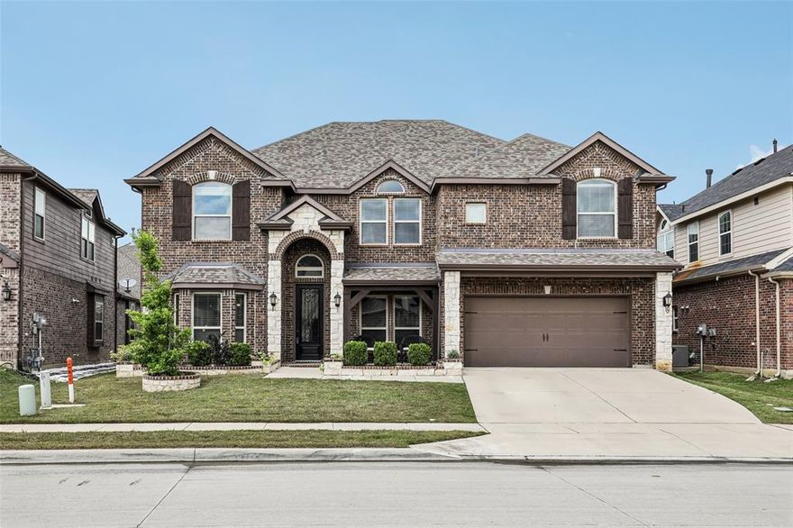 Located in a quiet, family-friendly neighborhood within highly sought-after Northwest ISD, this well-maintained and spacious home offers exceptional value with convenient access to Alliance and Presidio shopping, dining, and entertainment, plus quick access to I-35W. The elementary school is just a short walk away, making daily routines effortless. The upgraded stone accent façade and flower beds along with the comforting front porch greet you and welcome you in. Once inside the stunning soaring foyer featuring a grand curved staircase that sets the tone for the home’s elegant design. The open-concept floorplan showcases engineered hardwood flooring throughout the main living spaces, a formal dining room, and a spacious office perfect for working from home. The home is also pre-wired for hardline internet connectivity. The kitchen is designed for both functionality and entertaining, featuring stainless steel appliances, granite countertops, abundant cabinet storage, a butler’s pantry, with a large walk-in pantry. The inviting living area is anchored by a custom floor-to-ceiling stone fireplace that creates a warm and sophisticated atmosphere. The master suite is a retreat of its own offering dual sinks, plenty of counter space, soaking tub and walk in shower. Upstairs, you’ll find four spacious bedrooms along with a large game room and an impressive media room complete with a wet bar, edge-free 4K ALR 3D-ready projector screen, and pre-wiring for surround sound — perfect for movie nights and entertaining guests. Two full bathrooms feature custom tile flooring and walk-in showers for a modern, upscale feel. Outside, enjoy a covered patio and a generously sized backyard with plenty of room to extend the patio or create your ideal outdoor living space. Additional highlights include a new impact-resistant roof installed in 2021, which may qualify for insurance discounts.