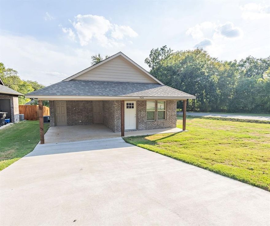 Pleasant, energy efficient 3 bedroom, 2 bathroom home in Denison on a corner lot!  This fully bricked home has recently been completed, is foam insulated, has a carport, and is ready for a buyer! Open living, dining, and kitchen. Laminate flooring throughout.  Kitchen offers quartz counter-tops, stainless steel appliances, including a refrigerator and a small pantry.  Decorative tile for kitchen backsplash, and shower walls in both bathrooms!  Primary bedroom has a door leading to the back porch.  The backyard has lots of room for those outdoor activities.  Come take a look today! Will not last long!