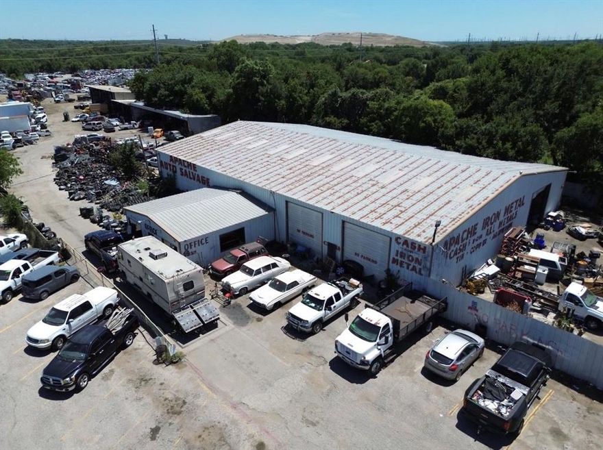 An extraordinary opportunity to acquire a highly visible commercial salvage facility on nearly 13 acres in the growing Kennedale corridor of the Dallas–Fort Worth metroplex. This expansive property spans approximately 12.976 acres with more than 1,375 feet of direct highway frontage along U.S. 287, offering scale, visibility, and strategic positioning in one of the region’s most active industrial markets. The site is fully fenced, gated, and improved with a 10,000+ sq ft metal building containing office and restroom facilities, a 70-foot in-ground truck scale, and a prominent highway billboard. Currently operating as an established salvage yard, the property benefits from long-standing grandfathered use rights and 50+ years of business goodwill. The seller is open to structuring a transaction to include equipment with on-site inventory and leasing the property for continued operations, providing multiple paths for a new owner or operator. Centrally located with immediate access to I-20 and I-820, the property sits just miles from Mansfield’s newly approved $2.5 billion entertainment district and a rapidly expanding base of industrial and commercial development. This positioning places it within a corridor experiencing substantial investment, traffic growth, and long-term demand. Infrastructure supports heavy commercial use, with utilities in place and multiple drive points for large truck and trailer access. Combining current operational capacity with future upside, this property offers a rare chance for investors, developers, or owner-operators to secure a large-scale, highway-fronting asset in a sought-after DFW submarket. Buyer and buyer’s agent to verify all information. Seller reserves all mineral rights. All offers should be submitted in writing to the listing broker.