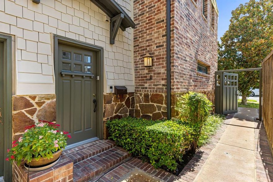 Welcome to 3420 Milton Avenue #A, a sophisticated, light-filled condo, perfectly positioned in the heart of Dallas’ highly sought after Snider Plaza area. This elegant front-unit residence overlooks both a beautifully maintained yard and charming Milton Avenue, offering an abundance of natural light through expansive windows that enhance the open, inviting layout. Inside, rich hardwood floors flow throughout, complementing the designer finishes and thoughtful details that define every room. The spacious living area centers around a striking pebble-surround fireplace and built-ins, creating a warm and stylish focal point for relaxing or entertaining. The open kitchen is equipped with granite countertops, stainless steel appliances, designer tile backsplash, and ample cabinetry, seamlessly blending beauty and functionality. Both bedrooms are generously sized, with the primary suite featuring a luxurious, spa-inspired bath and exceptional natural light. The secondary bedroom provides flexibility for guests, a home office, or media space. Each of the two and a half baths showcases elegant decorative lighting and high-end tile work, underscoring the home’s attention to detail. Additional conveniences include a spacious two-car garage with an extra storage room, a rare find in this prime location. Just steps from Snider Plaza, this townhouse offers an unmatched lifestyle with walkable access to some of Dallas’ best dining, boutique shopping, and cafés. Southern Methodist University is only a short stroll away, creating a dynamic yet peaceful neighborhood setting. Combining timeless style, modern comfort, and one of the most desirable locations in Dallas, this home presents a rare opportunity to experience refined urban living at its best