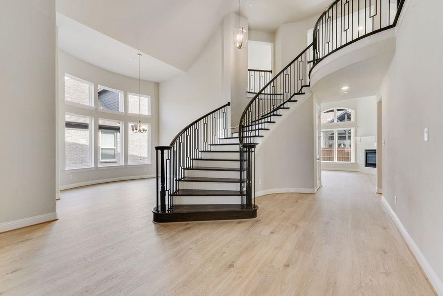 Experience luxury, comfort, and convenience in this stunning new Grand Home, scheduled for completion in November. Perfectly situated within the highly rated Mansfield ISD, this residence offers an ideal setting where all schools are just a short walk or bike ride away. Nestled between Dallas & Fort Worth, the home provides effortless access to premier shopping, dining, & entertainment options.
This Energy Star Certified property welcomes you with impressive curb appeal, an elegant eight-foot front door, and extensive hardwood flooring throughout. Inside, the open-concept layout showcases a vaulted family room with a cozy gas fireplace that flows seamlessly into a spacious covered back patio—perfect for relaxing or entertaining. The gourmet kitchen serves as the heart of the home, featuring Shaker-style cabinetry, Omegastone countertops, a five-burner gas cooktop with custom wood vent hood, stainless steel appliances, pots and pans drawers, and a generous island for casual dining or meal prep.
Designed for modern living, the home includes five bedrooms, with a convenient downstairs guest suite ideal for multigenerational families. The full oak staircase with wrought iron spindles leads to a large game room and an additional media or bonus space. The luxurious primary suite offers a serene retreat with a garden tub, dual Marlana vanities with framed mirrors, rectangular sinks, and a glass-enclosed tiled shower.
Additional highlights include eight-foot interior doors, rocker light switches, R-38 insulation, and a radiant barrier for exceptional energy efficiency. Combining style, functionality, and location, this home delivers the perfect blend of sophistication and everyday comfort in one of the area’s most desirable school districts.