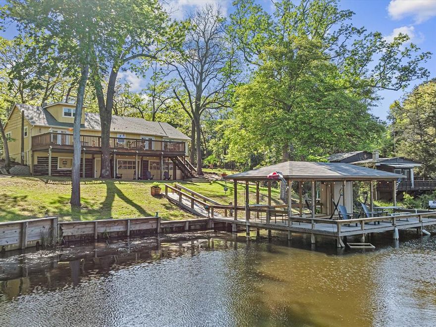Welcome to Lake Lydia and the home named by the locals THE MANSION ON LAKE LYDIA. This breathtaking lakefront estate is on DEEDED LAND that you would OWN, unlike most of the homes which are on leased parcels. Perfectly situated on the serene shores of Lake Lydia, this one-of-a-kind property offers a modern retreat for those seeking privacy, tranquility and unforgettable views. From the moment you arrive, the heart-felt love poured into this residence is undeniable. Views from the expansive windows, and sweeping verandas make a stunning impression. Inside, you'll find spacious, light-filled living areas, and custom craftsmanship throughout, ideal for intimate gatherings and large-scale entertaining. The enormous walkout basement with 2 rollup garage doors leading directly to the lake, make for an amazing hangout or workshop area. This lakeside paradise features multiple bedrooms, 3 to be exact, actually sleeps 10 and possibly more, clean updated baths, a large open kitchen boasting a huge island with top-tier appliances, and a dramatic great room with soaring ceilings, wood wrapped beams and serene water views. Step outside to enjoy Manicured grounds, a private boat dock with boat lift, with fish cleaning table and sink, a variety of outdoor spaces perfect for morning coffee, newly constructed front porch, sunset cocktails, fishing, roasting marshmallows, or just enjoying God's creations. Or enjoy the enormous newly rebuilt wood deck balcony overlooking the lake. Whether you envision it as your forever home, a weekend retreat, or and estate for you heirs, The MANSION ON LAKE LYDIA is more than just a property-It's a Legacy!  Lot size is based on the new surveyed lot next door which closed Friday, May 16th, 2025 with a new survey and new boundaries adding a little bit more land to this lot.  All the work has been completed concerning the documentation in transaction desk discussing basement retaining wall and repair estimate. Reasonable sellers, bring any offer!!!!!