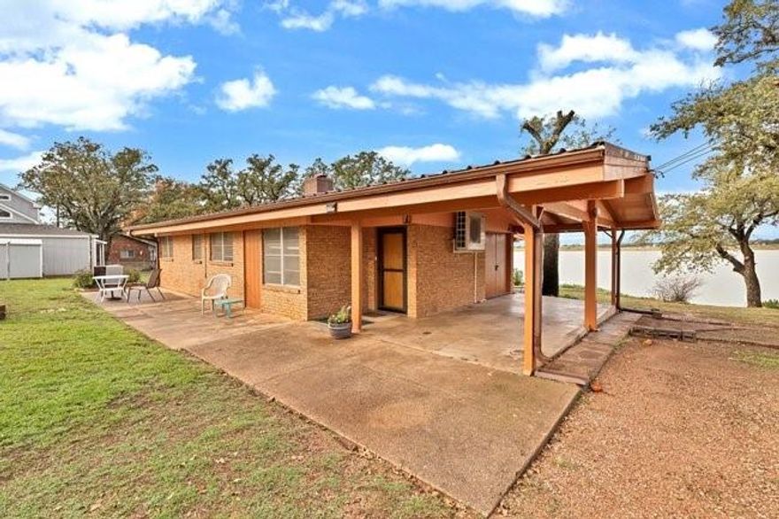 AS IS.  Lake cabin in a desirable, peaceful neighborhood overlooking Hubbard Creek Reservoir. Village Inn neighborhood, Deep-water location with elevated hilltop setting provides panoramic lake and sunset views year-round. Approx. 15x30 windowed room can serve as a second living space, sunroom, or extra sleeping area.Cathedral ceilings, wood paneling in excellent condition. Built-in living room shelving and cabinets for storage.New exterior paint & new water heater, New 2 ton Samsung mini split, Sandrock terraced backyard with flower beds. Front patio + shaded back patio. Oversized front yard for outdoor games and gatherings. Large carport storage closet & plenty of extra parking for vehicles and boats. The neighborhood loop road is perfect for walking, biking, and meeting neighbors. Minutes from Walmart and Breckenridge approx. 5 miles. Just a couple of miles to public boat ramps and Hubbard Creek Public Recreation Area with fishing, swimming, picnicking, and camping. Reservoir offers excellent bass fishing, and the area is known for deer, dove, quail, and duck hunting.