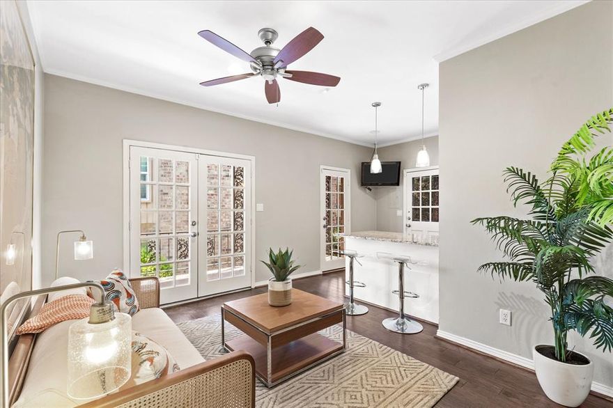 I am in love with this unique floor plan with the large combination living and dining with a fireplace plus a dry bar with wine fridge. The kitchen with its granite countertops and breakfast bar is open to the second living area (that used to be the third bedroom) with French doors opening onto a covered back porch. Views to the community pool from this large, covered porch expand the outdoor enjoyment from this charming living area. The primary bedroom is well sized with ensuite bathroom and large closet with built in drawers. The second bedroom, private from the primary with a full bath just off the hallway. Stacked washer-dryer remain in laundry room with extra storage space. Walking distance from shopping, dining, parks and river trails enhances the enjoyment of this fabulous condo. So much outdoor living without the upkeep of a yard and pool. Do not let being on Bellaire stop you from seeing this beautiful property- there is very little noise inside the condo, and you get to enjoy the manicured front yard.