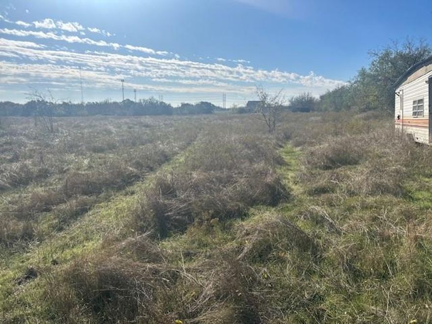 Over 3 acres of unrestricted land outside of city limits. Fully fenced and utilities already in places. Spacious land with 2 mobile homes and multiple sheds. Requires clean up but priced for a great investment property.