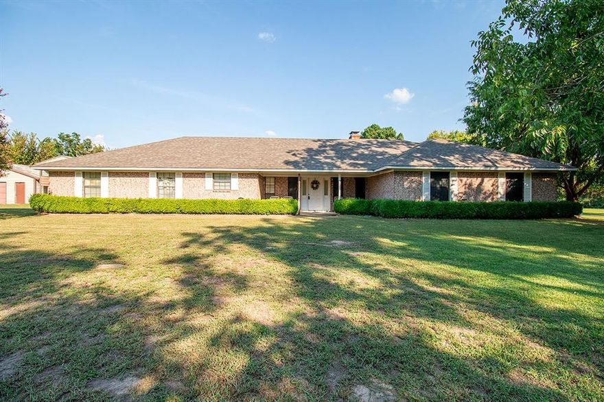 Charming 3-Bedroom Brick Home on 3.33± Acres in Grand Saline, TX. This beautiful 3-bedroom, 2-bath brick home offers both comfort and space on 3.33± acres. Featuring an attached 2-car garage, the property combines convenience with country living just minutes from town. Inside, the oversized living area boasts a large brick fireplace with built-ins, creating a warm and inviting centerpiece. The spacious dining area flows easily for gatherings, while the utility room includes a generous pantry for extra storage. Tons of natural light! The oversized primary suite features a full ensuite bath with a dressing area, and the two additional bedrooms are equally roomy as well. Enjoy outdoor living with a welcoming covered front patio and a large covered back patio overlooking the private backyard. The property is graced with mature pecan and peach trees, offering seasonal beauty and shade. A versatile wooden building - pole barn provides additional storage and space for a motorhome. Ideally located close to schools, shopping, restaurants, and just 20 minutes from Canton’s famous First Monday Trade Days, this property offers both peaceful living and easy access to local amenities. The family is in the process of clearing out the home, making it ready for its next chapter.