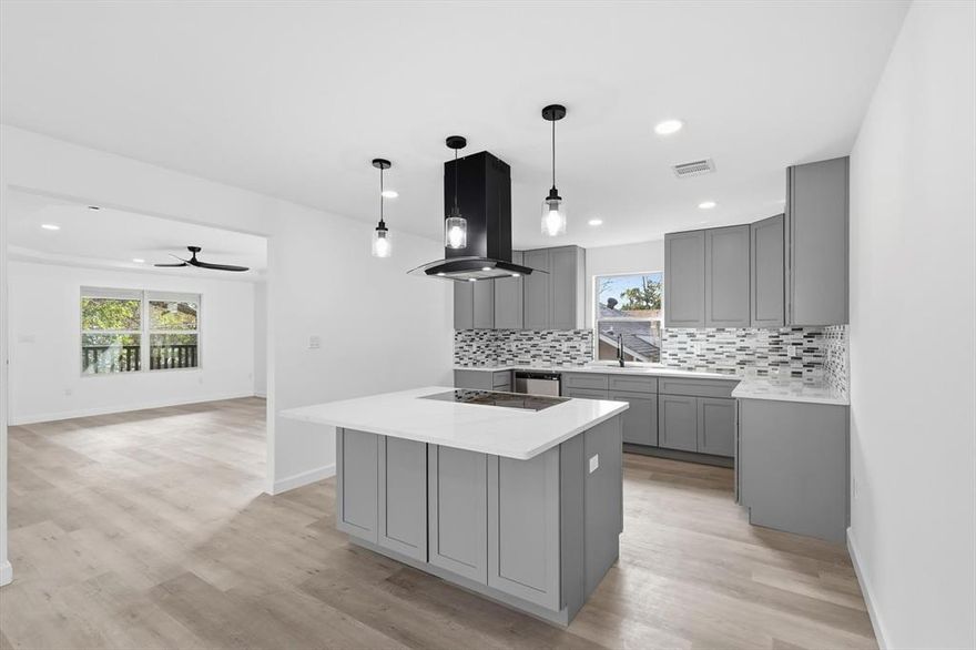 With every permit pulled and every inch reimagined, this property lives like a true NEW build. All major systems were replaced from the ground up: plumbing, electrical, HVAC, roofing, windows, and even the hot water heater. The result is peace of mind wrapped in timeless curb appeal. A covered front porch sets the tone for a warm welcome. Inside, the living room opens immediately, offering a natural hub for everyday life. Just off this space sits a full guest bath and a front bedroom. The heart of the home is the kitchen, completely rebuilt with brand-new cabinets, quartz counters, and a generous island with a cooktop that invites gathering and conversation. The dining room sits just beyond, framed by double doors that lead to an elevated patio overlooking the newly fenced backyard, creating seamless indoor-outdoor flow. With three bedrooms and three full baths, everyone gets their own retreat. The primary suite is unexpectedly large, offering a spa-like bathroom with double vanities, a soaking tub, a separate shower, and a walk-in closet. A second primary suite — also boasting its own private bathroom and walk-in closet — offers flexibility for multi-generational living or long-term guests. Ceiling fans in every bedroom add comfort year-round. Outside, the backyard offers true privacy thanks to new fencing, plus a sizable storage building with built-in shelving to keep everything organized. Additionally, the attic is framed to easily convert into liveable space if the future owners desire. If you love the idea of a brand-new home but crave character, this one delivers the best of both worlds. Move-in ready, worry-free, and thoughtfully designed from the first impression to the final detail.