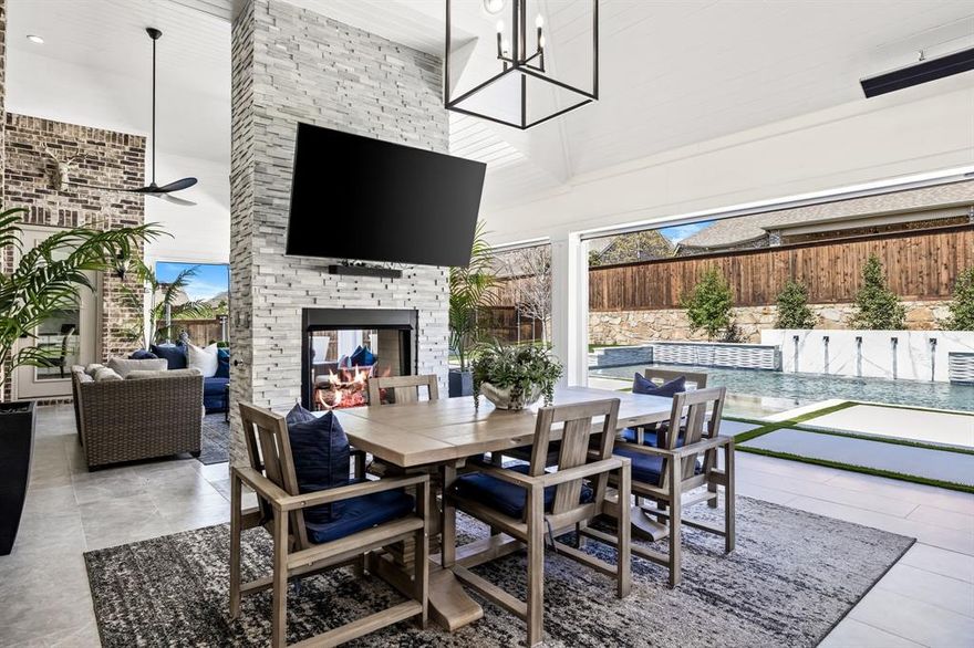 Indulge in resort-style living in the master planned community of Mustang Lakes, where this stunning home features sophistication & comfort. Thoughtful details include soaring ceilings, elegant wood floors & designer Restoration Hardware light fixtures throughout. Every BR offers its own full bath & walk-in closets. The spacious office is ideal for working from home. The dining room, adorned with a beamed ceiling, provides ample space for hosting gatherings. The gourmet kitchen is a chef’s delight featuring a large island, granite counters, gas cooktop, & abundant storage, plus a walk-in pantry, pull out spice drawers, with room to store appliances. Family room opens to kitchen & breakfast room & is centered by a cozy fireplace & floor to ceiling windows. The primary suite is a private retreat with separate vanities, garden tub, oversized shower, & large walk-in closet. Upstairs, a game room & media room with built in cabinets & fridge offer plenty of entertainment space. Find 2 additional BRs with full baths upstairs & walk out attic space. Enjoy outdoor living at its finest with a backyard oasis. The custom patio features dual seating areas, see-through fireplace, built-in outdoor kitchen with grill, smoker, & refrigerator plus bar seating. The custom hurricane-rated electric patio shades ensure comfort in any weather, allowing screens to stay down even in severe weather. The sparkling pool boasts water features, hot tub & built-in basketball goal, providing endless fun & relaxation. The surrounding turf & side yard offer room for play & 4 car garage with epoxy floors provides room for everyone’s vehicle. Includes whole house Generac Generator back up power. Enjoy stellar community amenities: resort-style pools, tennis courts, fitness center, clubhouse, fishing, basketball courts, miles of scenic trails & neighborhood elementary school. This stunning home offers a lifestyle that promises never-ending enjoyment & luxury.