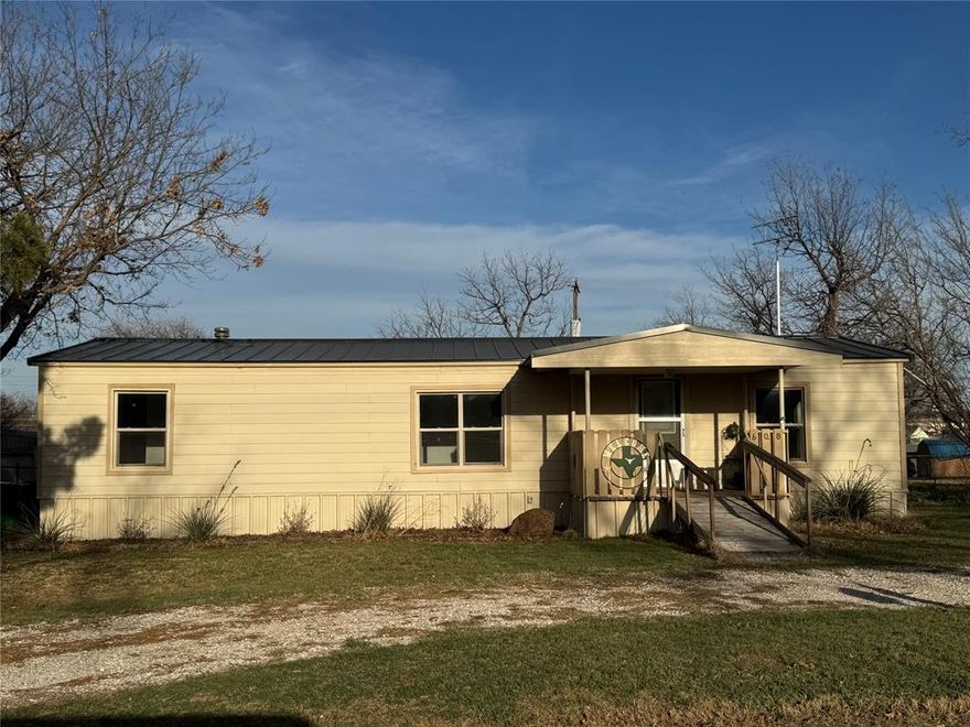 This stylishly updated 2-bed, 2-bath manufactured home features Hardie board siding, an open-concept interior, and modern bathrooms.  Nestled on a large lot, it includes a rear entry double carport and a versatile workshop. All appliances remain, and it's conveniently located close to the elementary school. Move-in ready—ideal for downsizing or a fresh start!