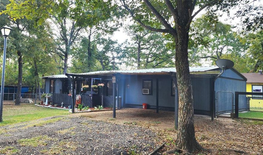 Charming frame built home at the lake, 14029 Sitting Bull Drive, Log Cabin TX 75148 in Log Cabin Estates. Fishermen - Cedar Creek Lake host tournaments here. Are you dreaming of your own get away while enjoying the fishing, boating and other recreational activities that Cedar Creek Lake offers? The home is a 3 bedroom, 1 bath frame built cottage with 1088SF built in 1995 on 4 lots totaling .19 acre. In 06-25 owner added thermostatically controlled Heat-Air Units. The hot water heater and washer, dryer are conveniently located in bathroom. The master bedroom includes an office nook (which could be converted to a full bath). Kitchen includes double sink, plenty of counter tops, and cabinets. Electric cooktop and propane oven.  Kitchen dining area. Metal Roof.  2 Carports. Termite maintenance plan. A 2023 Storage unit.  Need more space for an RV or want to add a tiny home to one of the lots?  One of the lots already has utilities ready for your RV or another home.  Want to add another home on Lot 681 (included) - already has a water-sewer hookup and 220 electric hookup with surge protection (10 yr transferable warranty up to $15k.) With the upgrade in 06-25 brand new thermostatically controlled Heat-Air units, the home may now qualify for FHA, VA, USDA loan.  Enjoy mornings on the front porch and watch the deer that come by. Log Cabin City amenities offer a boat ramp, park, swimming area, pier, outdoor grills, picnic tables and grills, and RV camping. Area events are held at the community center.  Enjoy country living, lake style at Log Cabin at Cedar Creek Lake. Information deemed reliable but not guaranteed. Buyer and buyer’s agent to verify all information including but not limited to schools, City rules, and measurements.