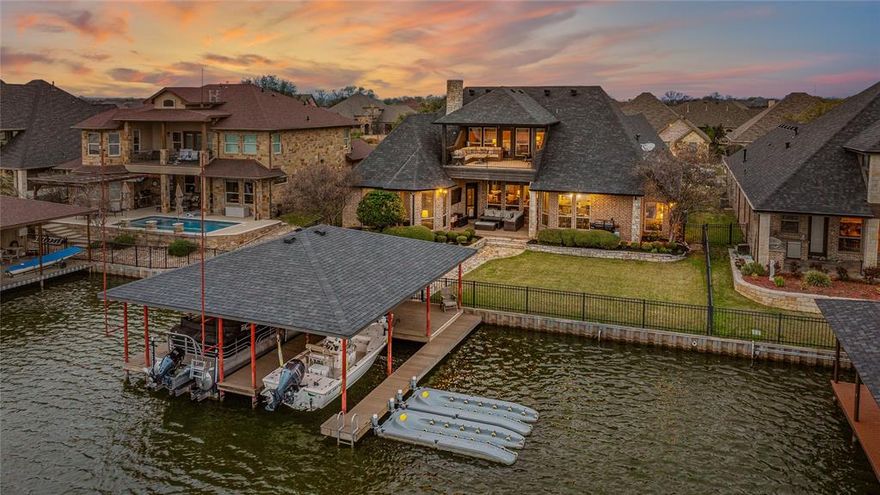 Fabulous Lakefront Home in One of Lake Granbury’s Most Coveted Gated Communities.Experience luxury lake living in this stunning home located in one of the most desirable, high-end developments on Lake Granbury. Featuring soaring ceilings and a spacious open floor plan, this home offers elegance, comfort, and exceptional lake views just minutes from Harbor Lakes Golf Course and the Historic Downtown Granbury Square. A custom iron front door with sidelights welcomes you into a beautifully designed interior highlighted by decorative ceilings, new LED lighting, rich hardwood floors, and a cozy wood-burning fireplace with gas starter. The gourmet kitchen includes the premium Compagnucci High-Tech organizing system, creating a highly functional and modern cooking space.Luxurious primary suite features a lavish en-suite bath designed for relaxation and comfort. Additional upgrades include spray foam insulation, central vacuum, and thoughtful custom finishes throughout. Enjoy peaceful main-body lake views without the heavy boat traffic, as the home sits in a protected deep-water cove. The impressive boat dock features TREX decking, a spacious entertaining area, and a durable stainless steel boat cradle built to last a lifetime.Outside, you’ll find beautifully landscaped grounds with a lake pump for irrigation. Additional features include a 3 car garage and an expansive attic space that could easily be finished into a game room or bunk room.