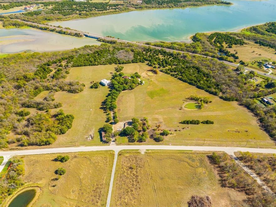 The subject property is a 30 acre site with a view of Lake Lavon. The property backs to the Corp Property fronting the lake. The custom-built home on site exceeds 4,000 sf with high quality interior finish design, additional living areas, including 4 bedrooms, 4 full baths, 3 half baths, 2 fireplaces, swimming pool, barns and outdoor living space including a tremendous balcony. Additional parking, garage space and an additional suite for family or business. The property is very private offering secured living near the lake, or development potential with direct linkage to Princeton, McKinney, Lucas and Allen. Ag Exemption in place currently. The views of both lake and land are beautiful. No Floodplain.
The manufactured home on site is not included.