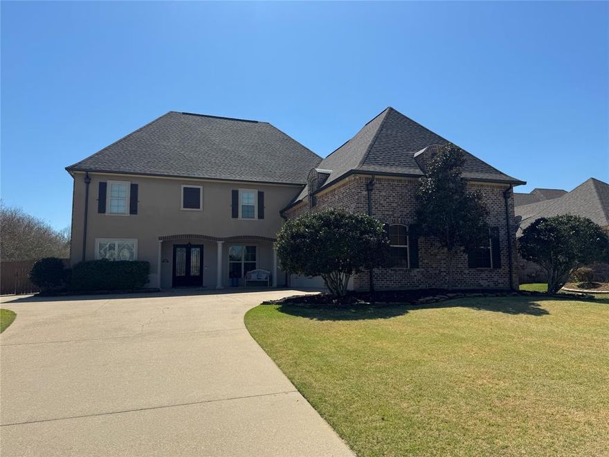 Located in the desirable Twelve Oaks community in Shreveport, this impressive 5-bedroom, 3.5-bath home offers over 4,000 square feet of beautifully designed living space. Built in 2009, the home features a spacious floor plan with elegant architectural details including brick archways, multiple living and dining areas, and a remote downstairs primary suite for added privacy. The kitchen is designed for both everyday living and entertaining with a large island, bar seating, double ovens, and abundant cabinet space. Upstairs you’ll find additional bedrooms along with a media or bonus room. Energy-efficient features include solar panels and upgraded insulation, helping keep utility costs low. Situated on nearly half an acre, the property offers a fenced backyard, flagstone patio, and peaceful outdoor setting perfect for relaxing or hosting guests. The gated Twelve Oaks neighborhood also offers community amenities including a pool, clubhouse, walking trails, and playground.  Special financing incentives available on this property from Sirva.