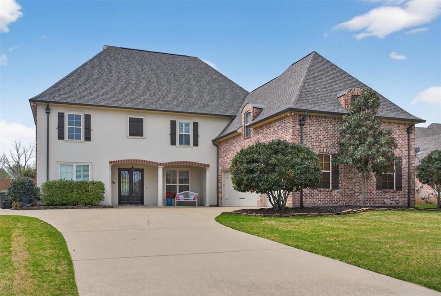 Located in the desirable Twelve Oaks community in Shreveport, this impressive 5-bedroom, 3.5-bath home offers over 4,000 square feet of beautifully designed living space. Built in 2009, the home features a spacious floor plan with elegant architectural details including brick archways, multiple living and dining areas, and a remote downstairs primary suite for added privacy. The kitchen is designed for both everyday living and entertaining with a large island, bar seating, double ovens, and abundant cabinet space. Upstairs you’ll find additional bedrooms along with a media or bonus room. Energy-efficient features include solar panels and upgraded insulation, helping keep utility costs low. Situated on nearly half an acre, the property offers a fenced backyard, flagstone patio, and peaceful outdoor setting perfect for relaxing or hosting guests. The gated Twelve Oaks neighborhood also offers community amenities including a pool, clubhouse, walking trails, and playground.  Special financing incentives available on this property from Sirva.