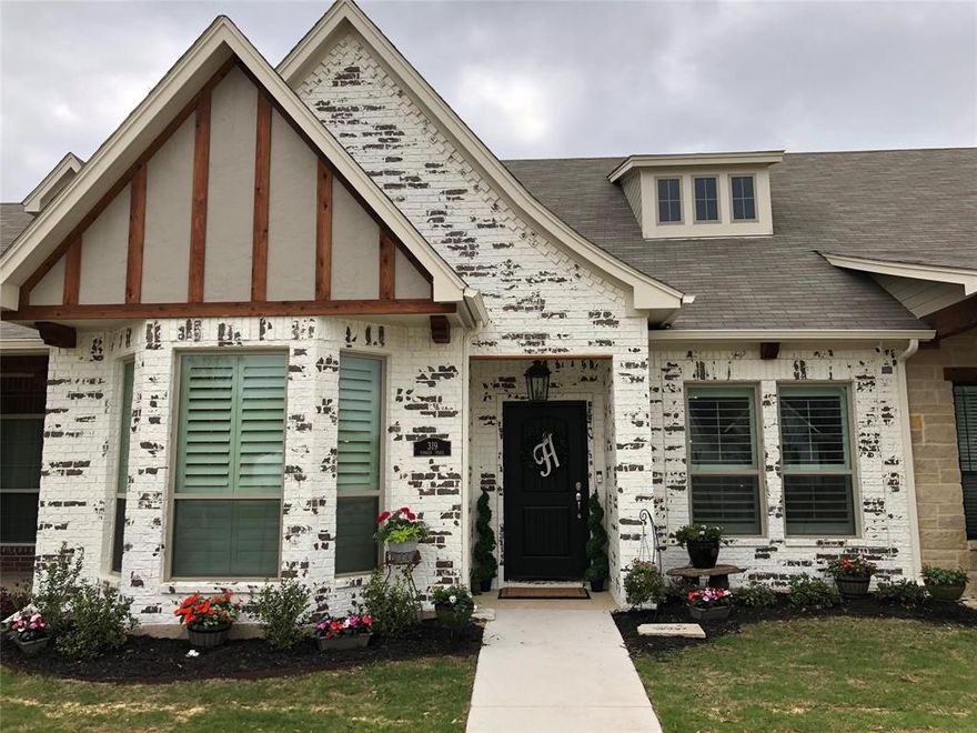 Welcome home to this beautifully appointed luxury townhome in the highly sought-after Heritage Village neighborhood of Burleson! Blending modern farmhouse charm with high-end finishes, this owner-managed property offers comfort, style, and thoughtful design throughout.

Enjoy scenic walks around nearby Bailey Lake or take a quick stroll or drive to Old Town Burleson, where you’ll find a delightful mix of local dining, shopping, and community events.

Inside, you're welcomed by rich hardwood floors, exposed wood beams, elegant wood shutters, and warm designer touches at every turn. The gorgeous kitchen is a standout feature with granite countertops, stainless steel appliances, an abundance of cabinetry, and a layout perfect for both everyday living and entertaining. A convenient half bath is also located downstairs for guests.

The spacious primary suite on the main floor includes a beautifully designed en-suite with a large soaking tub and comfort-height toilets for added luxury. Upstairs, you’ll find two more well-sized bedrooms and a full bath, ideal for guests or a home office.

Enjoy evenings on the covered back patio, and take advantage of the rear-entry garage for added privacy and curb appeal. Full yard maintenance is included, along with seasonal flower bed refreshes—making it easy to enjoy a low-maintenance, lock-and-leave lifestyle.

Pride of ownership truly shines in this lovingly maintained home. Come experience the charm and convenience for yourself!