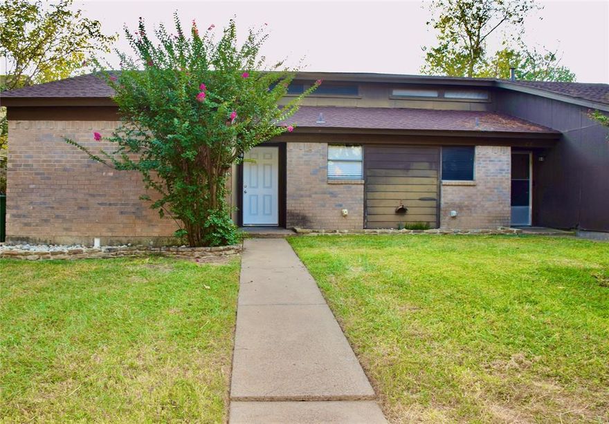 Charming Brick Bungalow in the Heart of Arlington. Step into this delightful 2-bedroom, 2-bathroom half duplex nestled  Arlington, TX. Offering the perfect blend of comfort and classic appeal, this home promises a serene lifestyle with modern conveniences at your doorstep.
As you enter, you'll be greeted by a spacious living area, complete with a charming brick fireplace that adds warmth and character to the space. This room is an inviting setting for relaxation and entertainment.  The kitchen is efficiently designed with a convenient layout that makes meal preparation a breeze. Each of the two bedrooms offers a cozy retreat, with the primary suite boasting a private bath for enhanced privacy. The second bath is easily accessible, thoughtfully serving guests and the second bedroom. The backyard provides ample space for outdoor entertaining or quiet evenings under the stars, creating an oasis of calm in the heart of the city. Though there is no garage, convenient street parking is available, offering easy access to your front door. This property provides easy access to Arlington's best amenities, from shopping and dining to parks and recreational facilities.