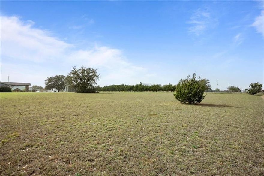 This one-acre commercial lot on FM 1713 offers exceptional visibility and accessibility, making it the perfect location for your business. With road frontage on both the front and back, this property is ideal for businesses that require rear parking or dual access. Located just a couple of miles from Lake Whitney and the popular McCown Valley Park, this high-traffic area attracts both locals and visitors year-round. The lot is already equipped with water and electricity. The property owner is also willing to include the three storage buildings with the property. Offering flexibility for buyers looking for a ready-to-use setup or a customized build-out. Whether you're looking to establish a retail business, office space, service shop, or investment opportunity, this strategically positioned lot provides endless potential. Don’t miss out on this rare commercial opportunity in a growing and sought-after area!
