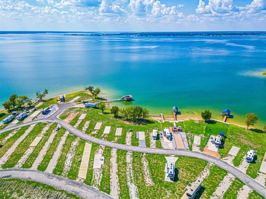 This fantastic lakefront property is eagerly anticipating your arrival to experience the upscale RV and tiny home resort on the beautiful Richland Chambers Lake. This lot offers a concrete pad already in place for you to bring your RV. Take in the spectacular views of the open water, enjoy both sunrises and sunsets with Richland Chamber Lake surrounding you on three sides. The community offers a clubhouse with many resort style amenities from a pool, laundry room, outside grill area, playground area, dog park, pier, fire pits with seating area to enjoy the sunsets, and it just goes on! Lake life is calling!