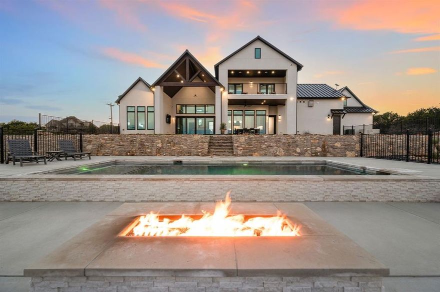 MAGAZINE-FEATURED newly built, HIGH END, Lake Resort Private Estate, perfectly situated on three golf course lots with expansive, unobstructed views of The Cliffs Resort Championship Golf Course and the Brazos River Valley. Live luxuriously in this secluded Private Golf Country Club stone and stucco New Construction Residence with level 4 impact resistant Metal Roof. TURN-KEY with Custom Furniture and Artwork included. Designed with superior craftsmanship, Innovative Technology, and luxurious comfort in mind, this 4,000 sq. ft. MASTERPIECE offers a seamless blend of indoor-outdoor living and exceptional attention to detail. 5-bedroom, 4.5-bath home features 12 ft first floor ceilings, 25-ft ceilings in living room, soaring black Cambria quartz jumbo slab fireplace with high output Linear Fireplace. Custom Marvin Windows with Automated Window Coverings for seamless indoor-outdoor living. High-end finishes include Cambria Quartz Countertops, Viking Appliances, custom cabinetry, extensive tile work, and an elegant stainless-steel Elevator. Smart Home Technology fully wired centralized HUB to operate home remotely, FIBER WI FI with Starlink Backup, a Whole-House Auto-Switch Generator, and 2,000-gallon underground Propane Tank, High End Security System, concrete Storm Shelter, and Wrought Iron Fencing all add convenience and security. Delight in the private auto fill Heated Saltwater Pool, glass rock Firepit, and Pool House with extensive decking. Multilevel, landscaped and irrigated lawn with engineered Rock Retaining Walls. Oversized Four Auto Garage with Boat Storage. Enjoy World-Class Golf Country Club amenities and dining in the Clubhouse, while savoring the privacy and scenic beauty of this grand and impressive, new construction Resort Estate. Includes transfer of a LARGE MARINA BOAT SLIP with Boat Lift at the close-by Full-Service Marina and full access to the adventures of Possum Kingdom Lake Texas.