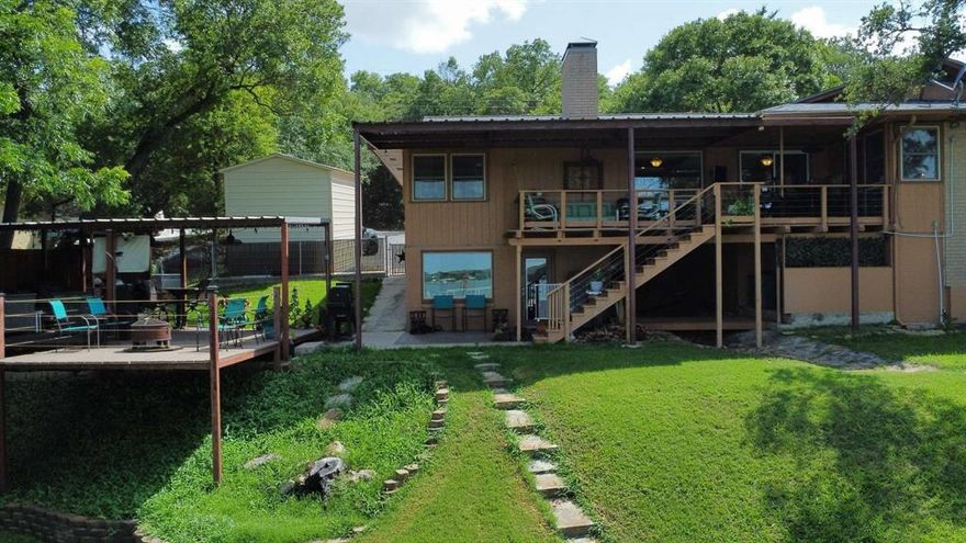 This 3-bedroom, 2.75-bath lakefront home offers an inviting open-layout feel and everything you need for relaxing lakeside living, including a private boat dock equipped with two boat lifts—one of which holds a pontoon boat. Please note, current water levels are approximately 18 feet below the dock. Each of the three bedrooms has its own bathroom, providing added comfort and privacy for family and guests. The home is fitted with high-quality Pella windows throughout, bringing in natural light and enhancing energy efficiency. Not to mention the gorgeous original hardwood floors!  Additional features include a small shop, a separate storage building, and an outdoor kitchen space perfect for entertaining. The main living area is all on one level, with an additional private bedroom and bathroom located on the lower level—ideal for guests or extended stays. Very nice deck off the living room for enjoying the lake view and outdoors. Call today to schedule your private tour and experience the best of lakeside living! 
Sellers 22 ft Sun Tracker pontoon boat (2016) for sale.