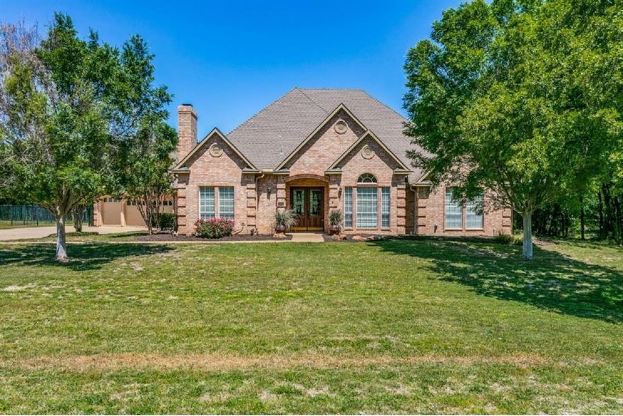 This beautiful 1-story Southlake custom home is situated on over 1.4 acres with mature trees and a creek.  It offers 4 bedrooms, 3-way split, with 3 and one-half baths.  There is a gas fireplace and wood flooring throughout the family room and breakfast area. The home boasts a covered patio and lots of windows overlooking a large diving pool, perfect for hot summer days. This property has 2 garages offering covered parking for 5+ cars.  The 3-car attached garage has 220 power and a sink and toilet.  The detached garage workshop has a large door, heat and air and 220 power. Recently installed new roof shingles and gutters along with a new air conditioning and heat system as well.. The back of the property is equipped with two large storage sheds. The home sits on a corner lot in a cul-de-sac providing additional privacy. The property is in the Southlake Carroll ISD, an award-winning school district. The aerial photos show how close the property is to Lake Grapevine.