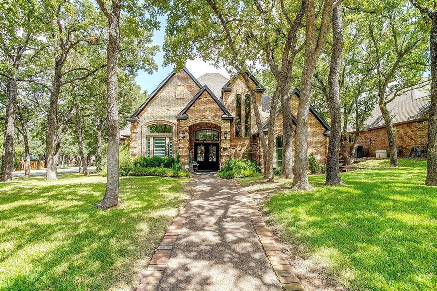 Beautifully remodeled home in Keller ISD, completely remodeled from the master ensuite, to all new wood floors, designer lighting & more. The home is enveloped with a canopy of lush trees & landscape. Stunning with modern touches & character plus. You walk into a grand foyer with a tall ceiling, open staircase with wrought iron & then into a dramatic living room with a center fireplace overlooking the beautiful backyard pool oasis. The master retreat has a standalone tub, separate shower, 2 separate sinks & a large walk in closet. From the master is access the manicured backyard. The updated chefs kitchen has an eat in area, casual lounge living area & a wet bar. Another bedroom & full bath on the first floor. Enjoy evenings in the separate upstairs game room with its own staircase. Take the front stair case to the other 2 bedrooms with a library wall in the hall. The upgraded pool has a wifi controller, pool pump & Polaris. 8' privacy fence around the backyard with a gated driveway.