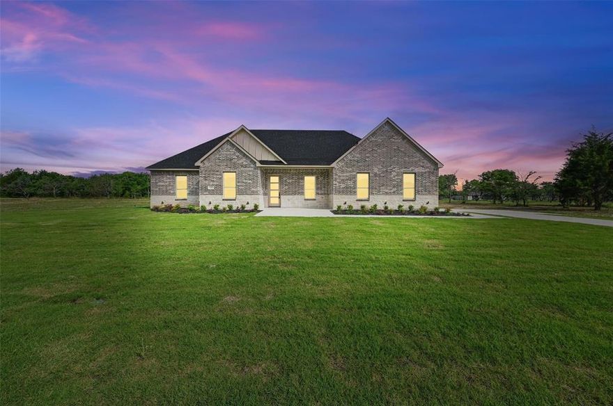 Limited-Time Builder Incentive! Receive up to $10,000 in seller concessions apply it toward your closing costs or use it to buy down your rate and save more every month. WELCOME to this stunning 4-bedroom, 2-bathroom home in the highly sought-after Grison Estates, set on 2 acres of peaceful countryside within Mildred ISD. Showcasing a beautiful stone and brick elevation, this home features ceramic tile flooring, elegant quartz countertops, and a custom-built fireplace with views into both the kitchen and backyard. The kitchen offers generous counter space and cabinetry ideal for both everyday living and entertaining. The spacious primary suite is a true retreat, complete with a custom accent wall, a spa-inspired bathroom featuring a walk-in shower, freestanding tub, dual vanities, and a large walk-in closet. Step outside to a covered back patio perfect for enjoying serene mornings or stunning sunsets. Additional upgrades include full spray foam insulation, foundation piers for added stability, and a full irrigation system. This home blends luxury, comfort, and functionality don’t miss it!