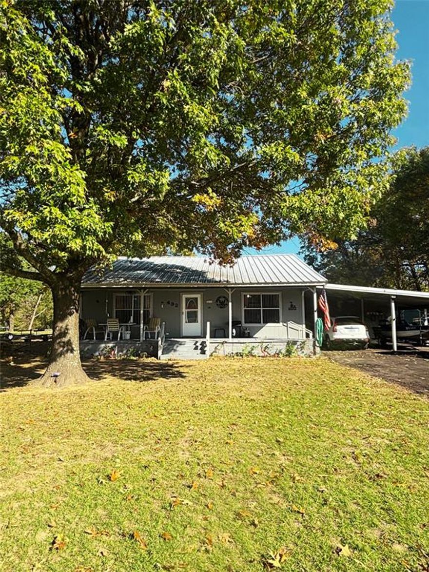 Lake life with out lake front taxes! Approximately two thirds of an acre in a must see Lake Fork neighborhood! Adorable, well kept and maintained two bed, one bath home with a full length covered front porch and back deck just big enough to relax with your morning cup of coffee. Asphalt driveway leading to a two car carport with a nice sized attached workshop.  Established shade trees. Neighborhood boat dock. BRAND NEW SEPTIC SYSTEM installed March of 2025!