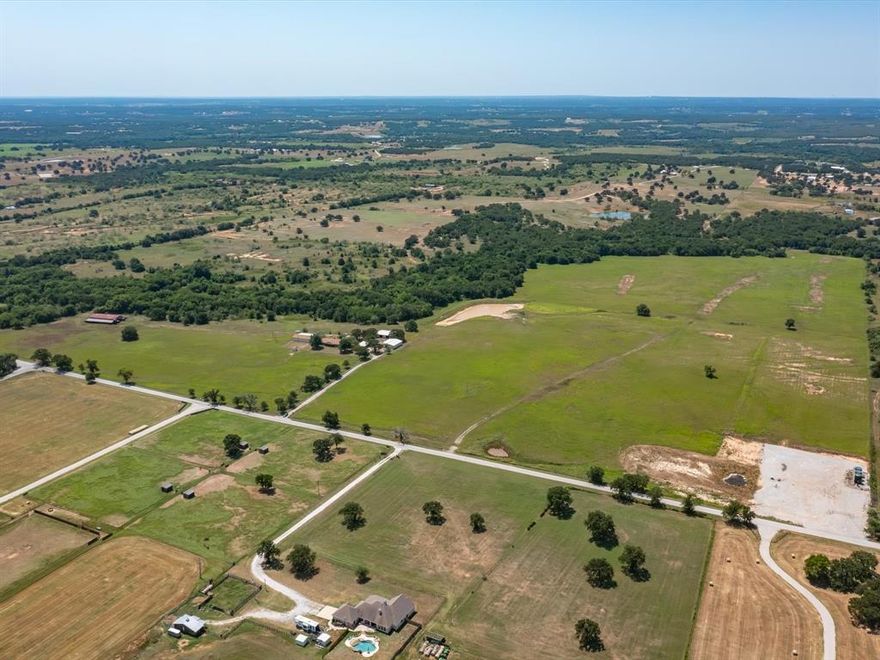 If you are looking for more land, we have more available so please ask! The parent tract of land is approximately 95 acres, see MLS number .........The location could not be more desirable! You can see the stars at night, and you are only 10 minutes to the grocery store.  Approximately 597 feet of paved county road frontage. The home is a three-bedroom 2-bathroom ranch style home with a wood burning stove new class four shingles as of last year. Included is the property you'll have, two 40x50 metal shops with electricity and one shop 28x56 with an 22x50 overhang faced with metal that has withstood high winds TWICE! Behind the home is a large pond that brings in lots of wildlife for you to enjoy from the covered back patio. High producing hay fields on Lot 1 and Lot 2.  Come out to Paradise and see what it has to offer you!